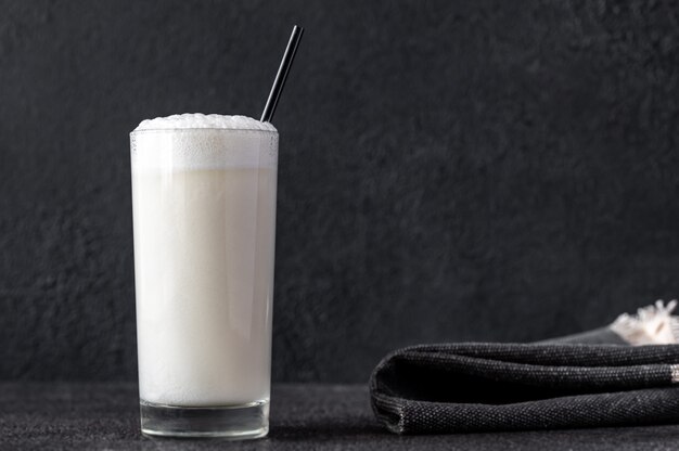 Glass of Ramos Gin Fizz Cocktail on dark surface