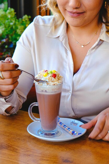 Glass of raspberry milkshake with whipped cream and fresh raspberries