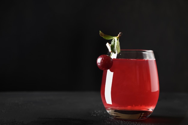 Glass of red cherry beverage or summer compote