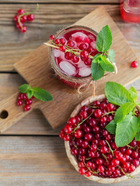 Glass of red currant cocktail or mocktail, refreshing summer drink with crushed ice and sparkling water