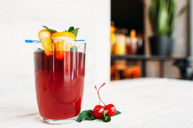 Glass of red mulled wine with orange free space