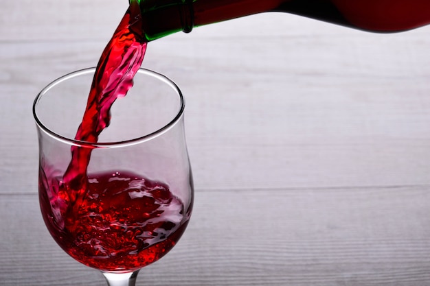 glass of red wine .glass of wine on a light wooden background