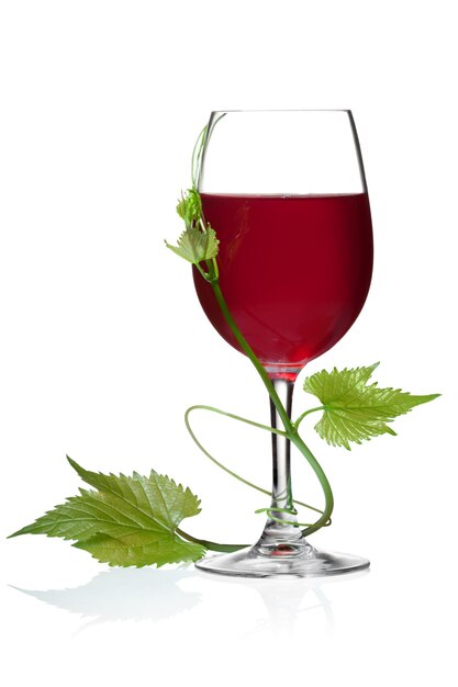 Glass of red wine and grape leaves on a white background and with soft shadow