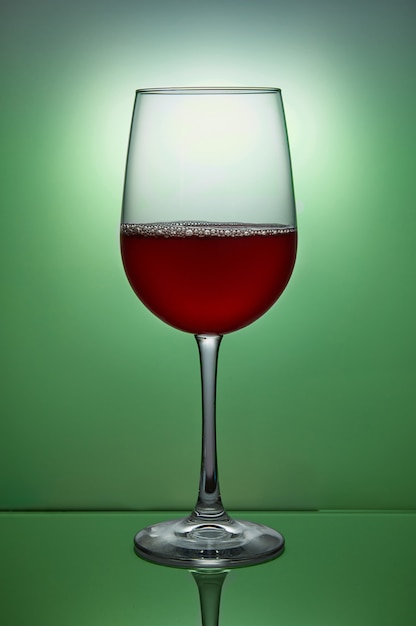 Glass of red wine on green