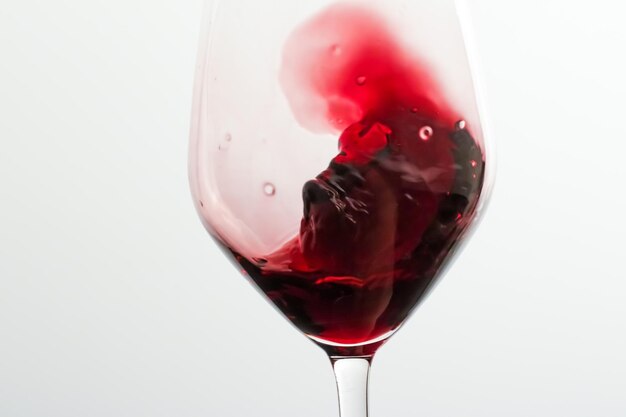 Glass of red wine pouring drink at luxury holiday tasting event quality control splashing liquid motion background for oenology or premium viticulture brand