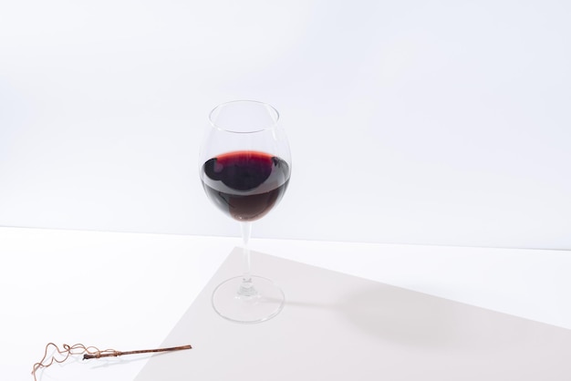 A glass of red wine on the table Light background