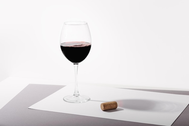 A glass of red wine on the table Light background