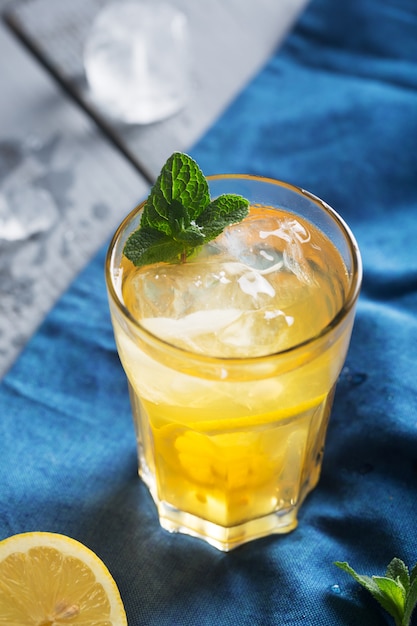 Glass of refreshing homemade lemonade with ice and mint