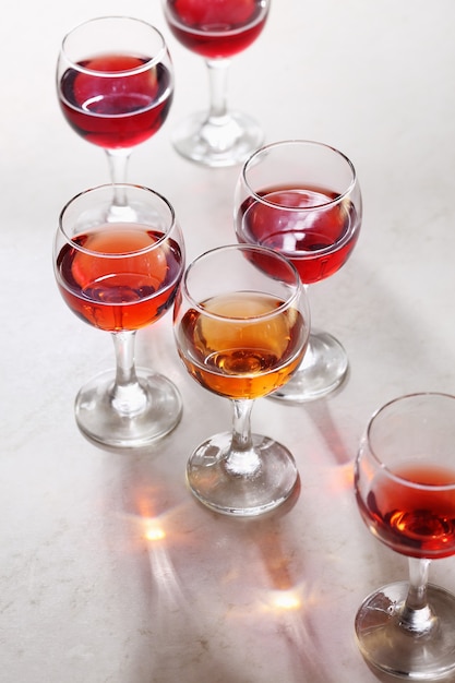 Glass of rose wine on white table