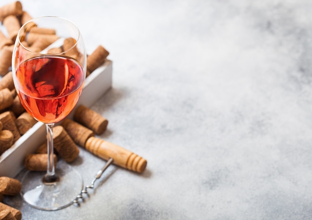 Glass of rose wine with lots of corks