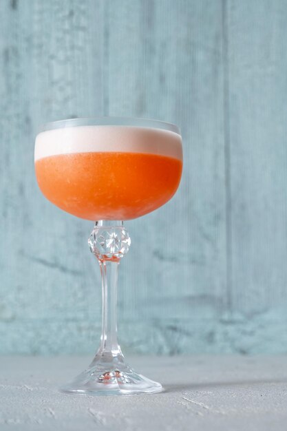 Glass of Ruby Cocktail on the wooden background