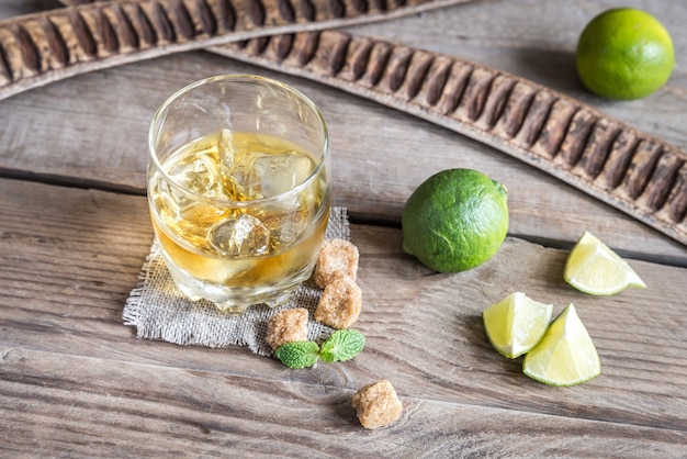 Glass of rum on the wooden background