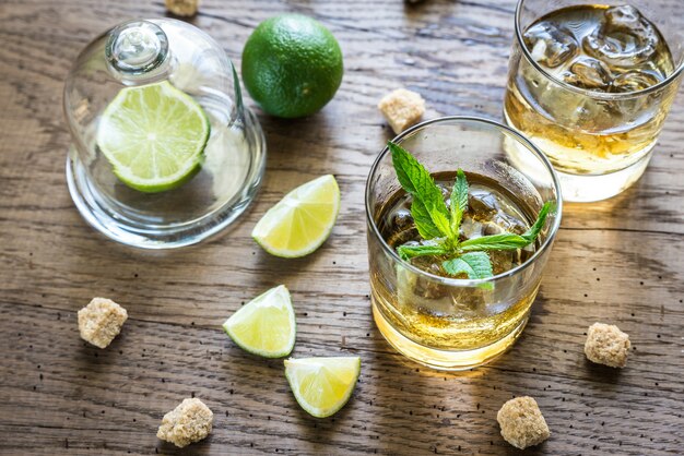 Glass of rum on the wooden background