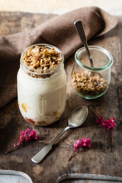 Glass of sauteed apple, natural yoghurt and granola