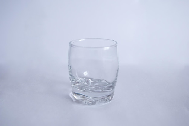 A glass shot glass for drinks on a white background