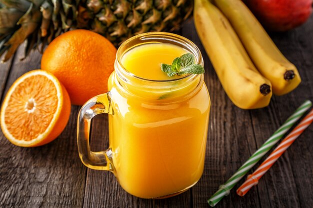 Glass of smoothie with fruit, selective focus.