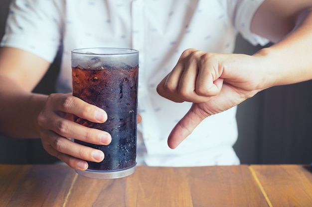 Glass of softdrink splashing with ice 