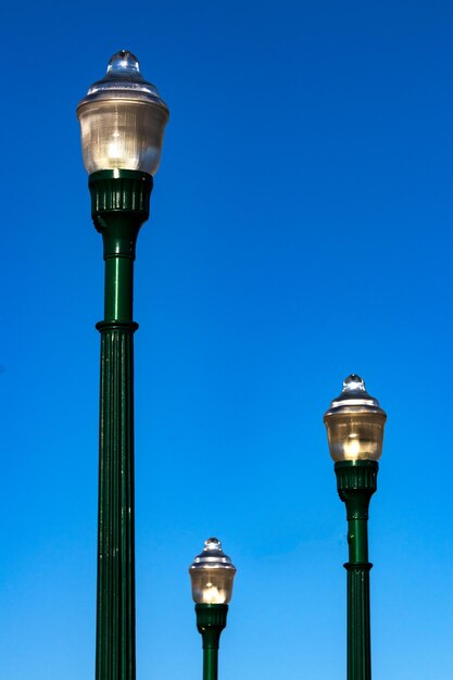 Glass street lamp head on a cast iron post