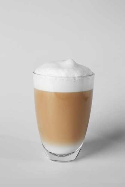 Photo glass of tasty frappe coffee on light