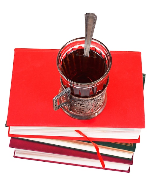 Glass of tea on stack of books