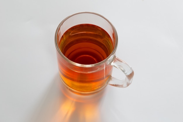 Glass of tea on white background