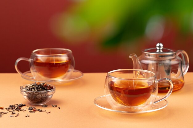 Glass teapot and glass cups with tea