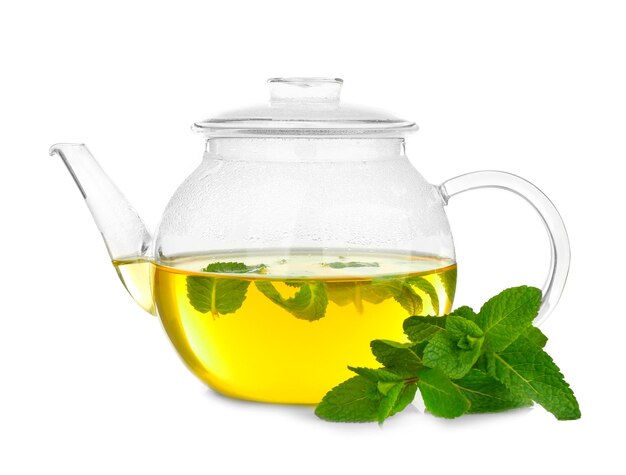 Photo glass teapot with hot tasty lemon balm tea on white background