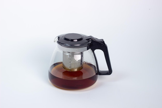 Glass teapot with tea on white background