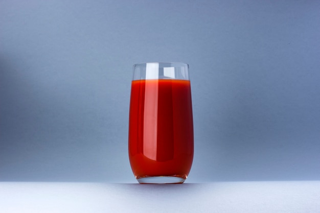 Glass of tomato juice isolated on white background with copy space