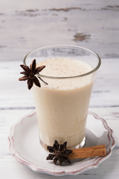 Glass of traditional indian chai tea with star anise and cinnamon