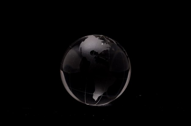 Photo glass transparent globe earth on a black background