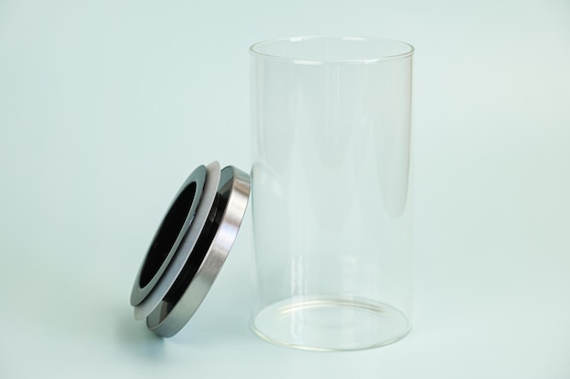 Glass transparent jar for bulk products with a vacuum lid on a pale green background