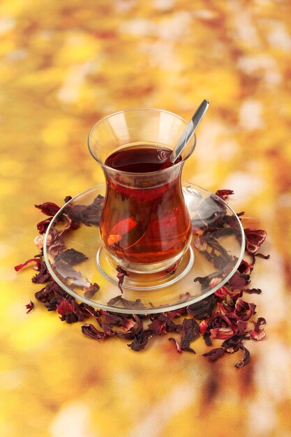 Glass of Turkish tea on color background