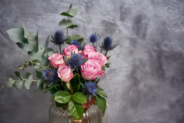 Glass vase with beautiful bouquet on color background