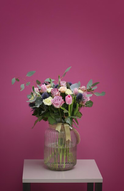 Premium Photo | Glass vase with beautiful bouquet on color background