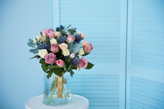 Premium Photo | Glass vase with beautiful bouquet on color background