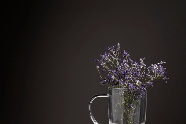 Glass vase with dried lilac flowers and copyspace