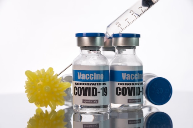 Glass vials for Covid-19 vaccine on white wall