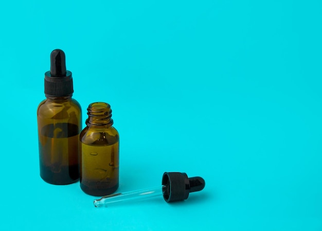 Glass vials and a pipette on a blue background