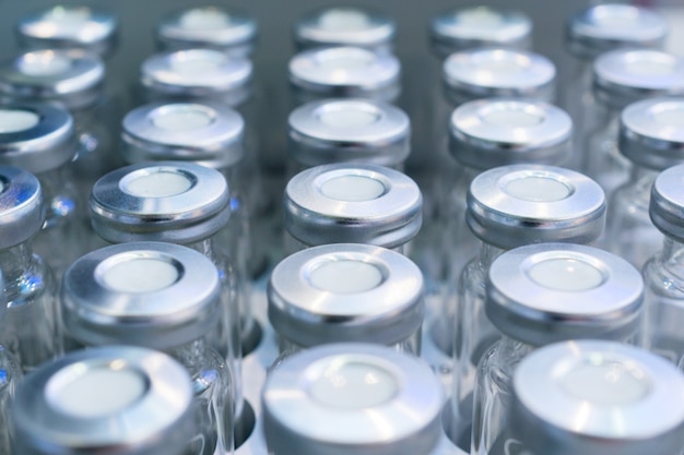 Glass vials for samples. Laboratory equipment for dispensing fluid samples. Shallow depth of field.