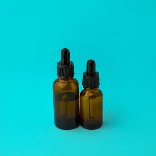 Glass vials with a pipette on a blue background