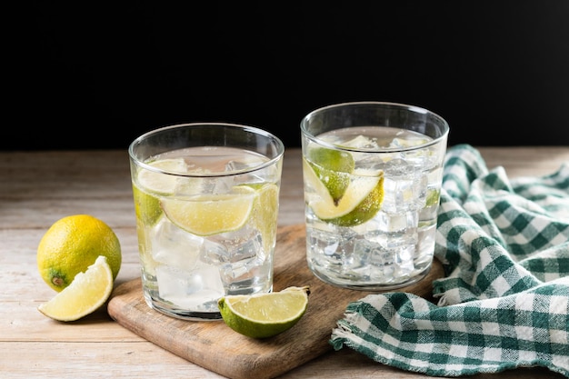 Glass of vodka tonic cocktail on wooden table