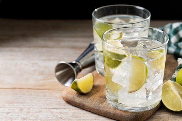 Glass of vodka tonic cocktail on wooden table