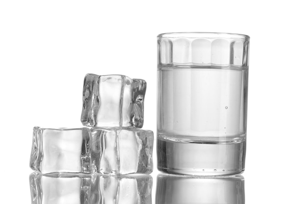 Стакан водки со льдом изолирован на белом