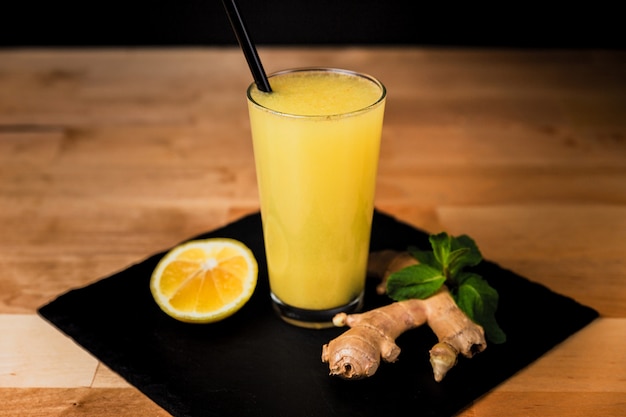 Glass of warm ginger drink with lemon, honey and mint