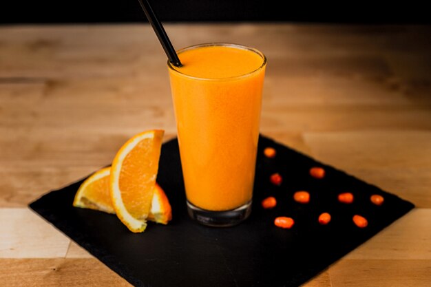 Glass of warm sea-buckthorn drink with orange