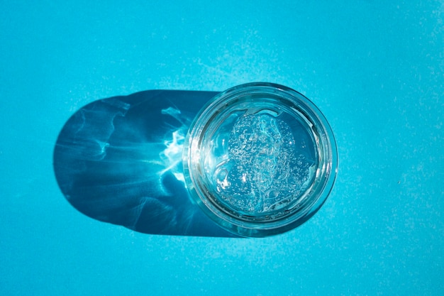 A glass of water on a blue background