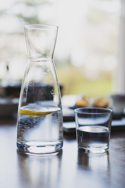 Glass of water and a decanter on the table in the cafe