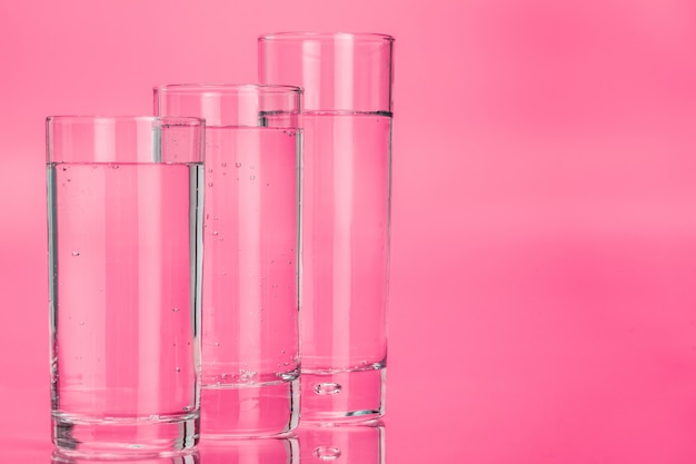 glass of water on pink