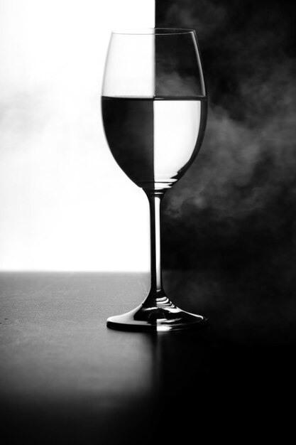 A glass of water and smoke on a black and white background